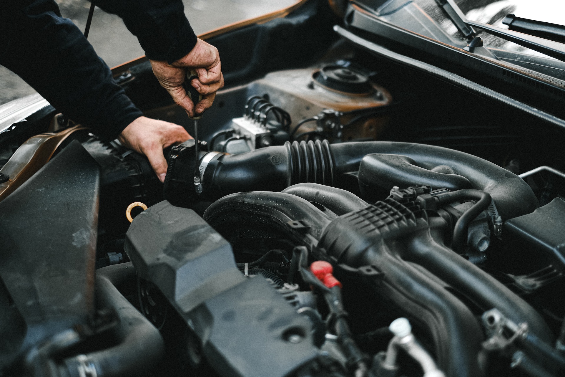 car mechanic working on engine